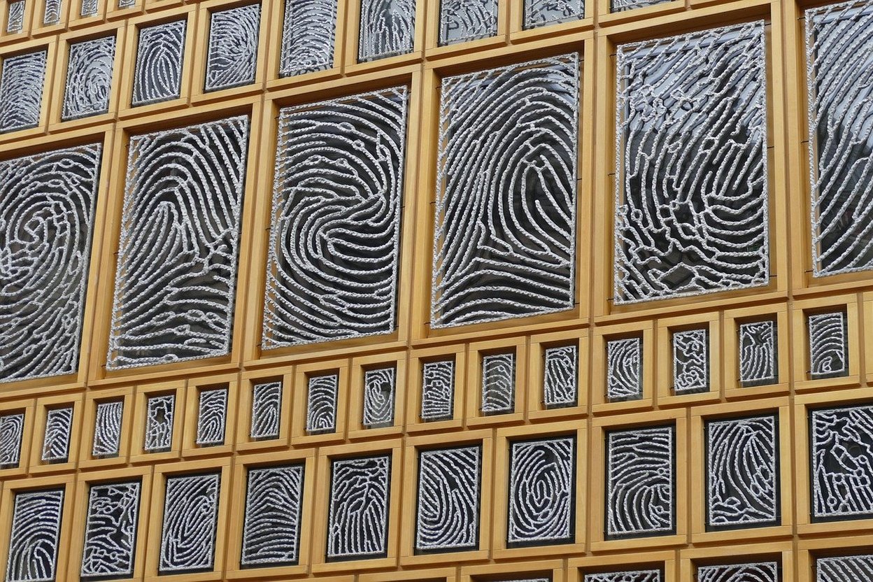 Wall of fingerprint patterns in golden frames.