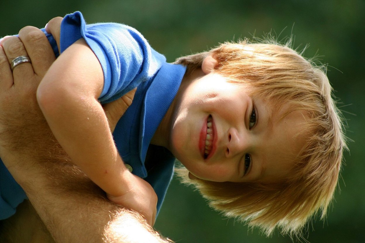 A smiling boy with cheek dimples