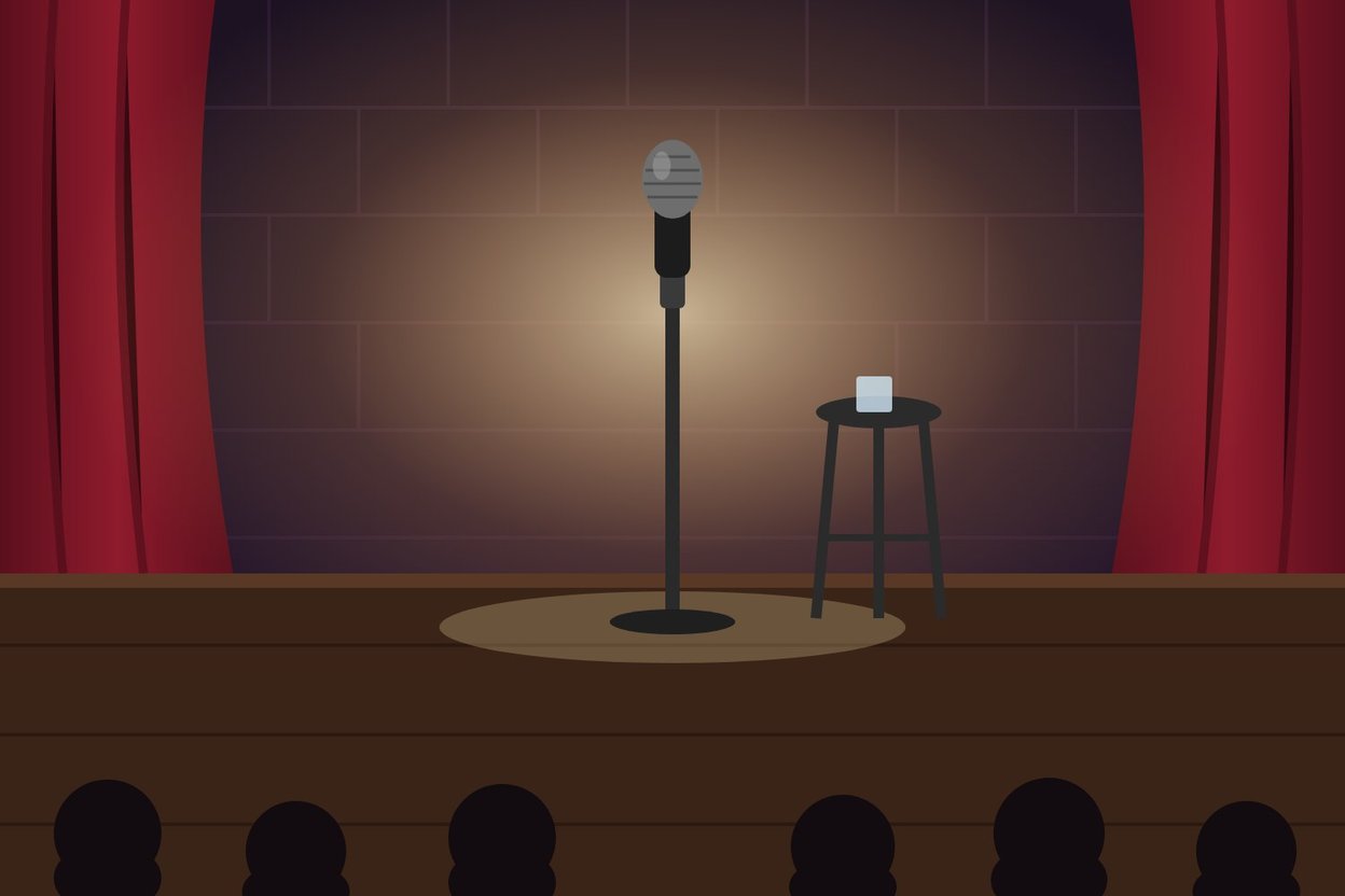 A comedy stage with a microphone under a spotlight
